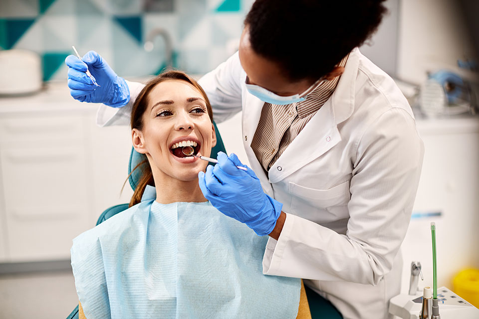 woman getting a dental exam at the dentist